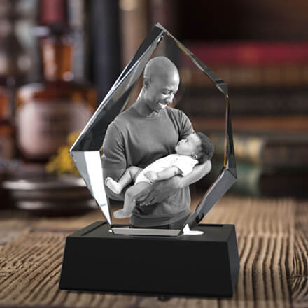 An image of a mother holding her baby laser engraved in a 3D photo crystal iceberg